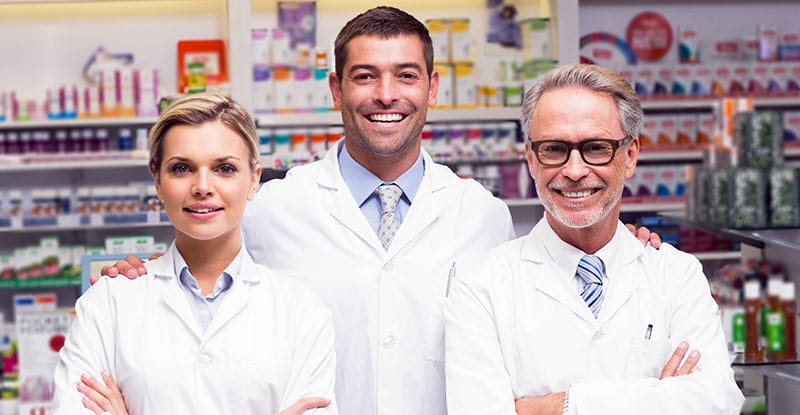 Portrait of smiling doctors standing in row at hospital premises